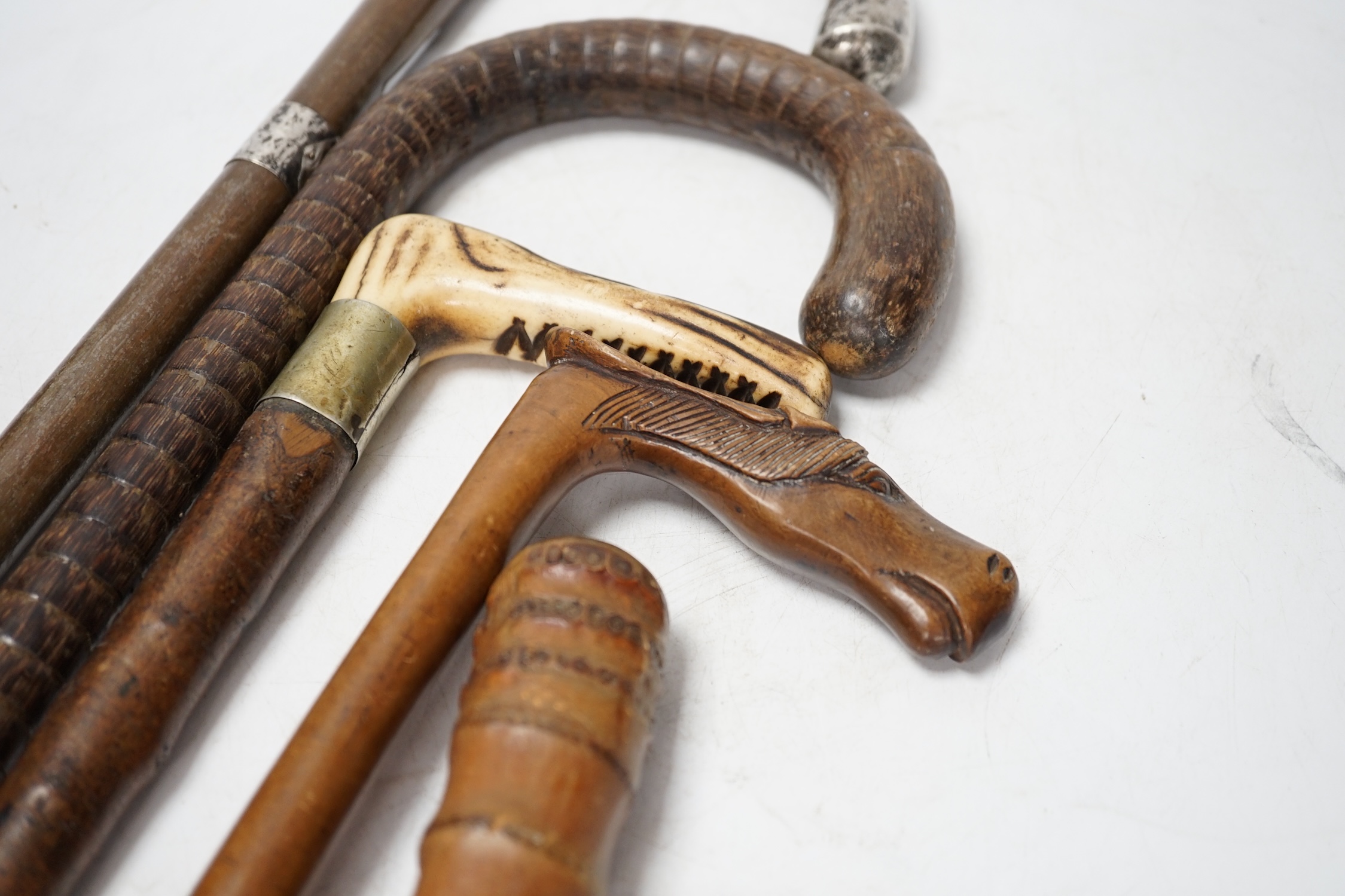A collection of five various walking sticks/canes including silver mounted, longest 93cm. Condition fair
